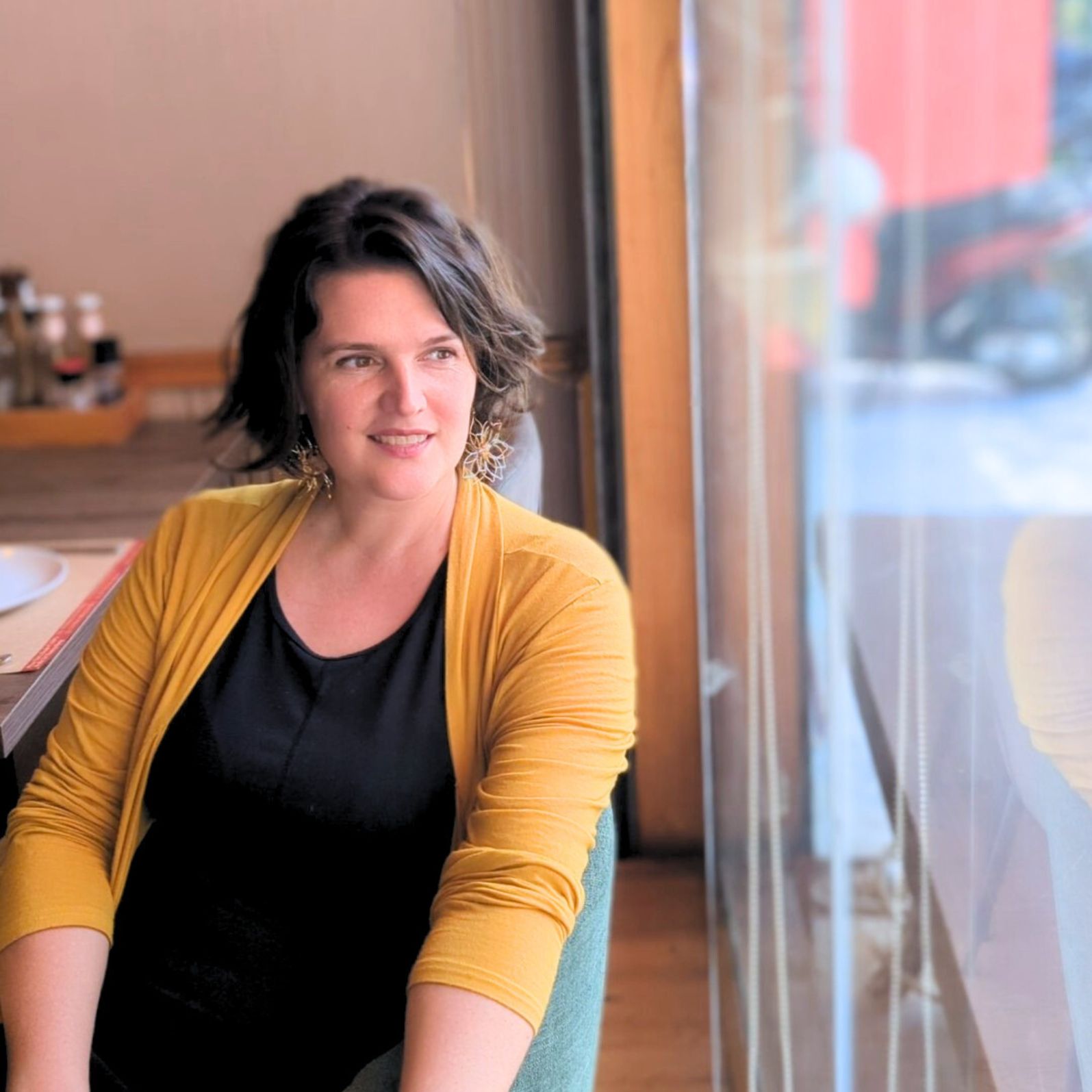 A woman looking at a window
