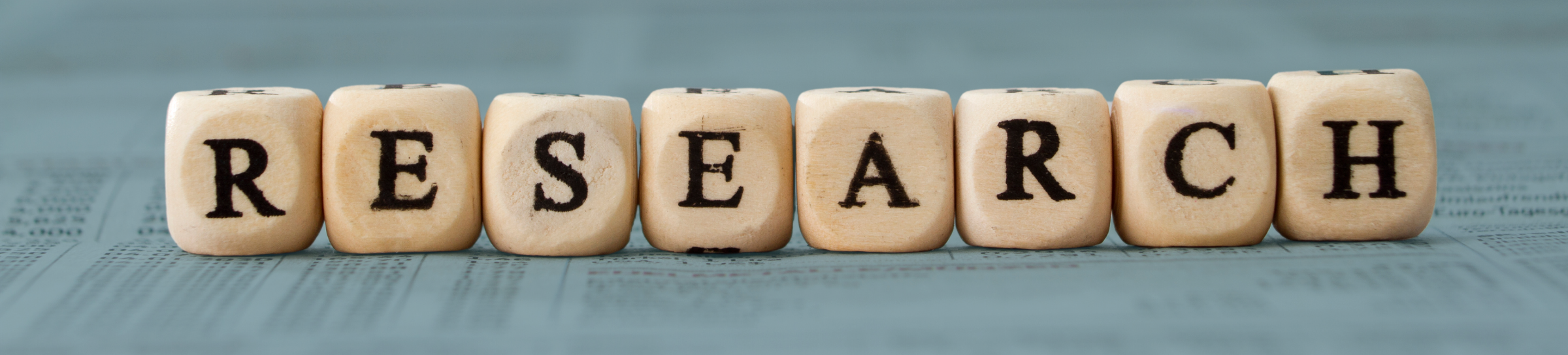 Letter dice spelling out the word "Research"